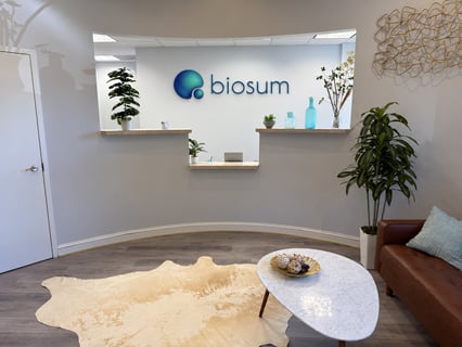 The biosum studio lobby, with the biosum logo mounted above the reception desk